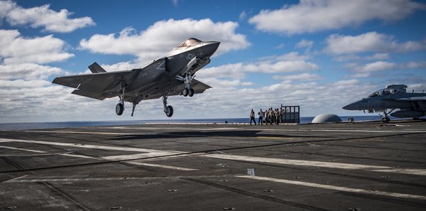 A U.S. Navy F-35C Lightning II lands on an aircraft carrier deck. The Navy's latest jet recently completed a major milestone as it prepares to join the fleet.